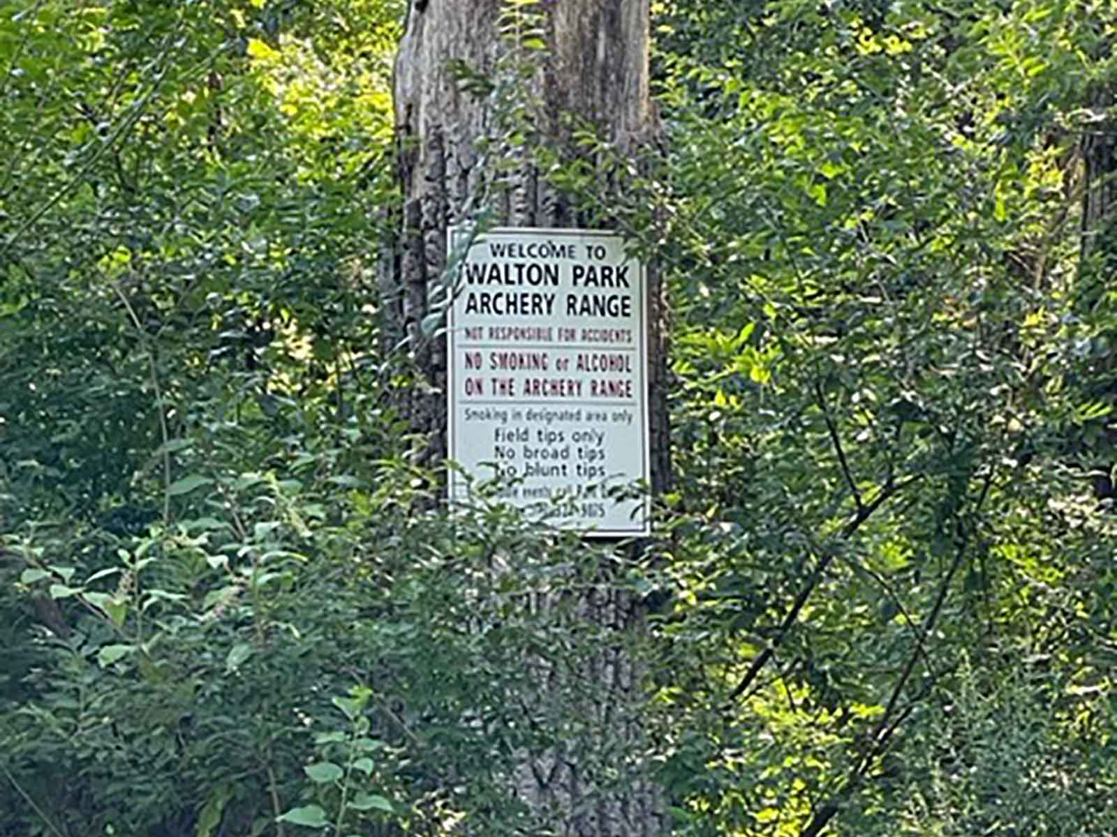 archery range rules sign attached to a tree