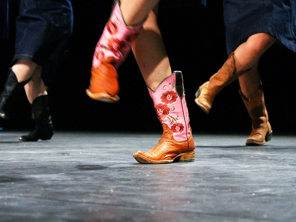 people dancing in cowboy boots