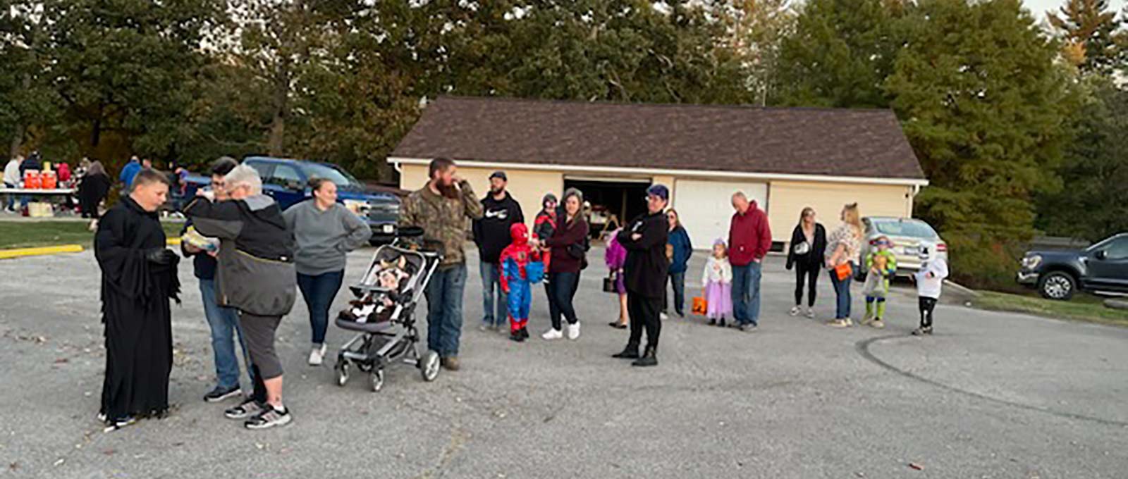 children in line receiving candy at our annual trunk or treat event