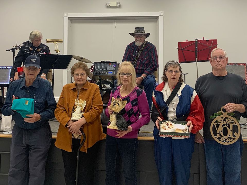 people standing near a stage with gifts they received